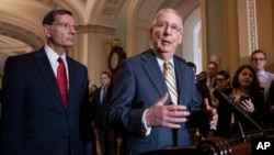 Senate Majority Leader Mitch McConnell, R-Ky., joined at left by Sen. John Barrasso, R-Wyo., speaks to reporters about the political battle for confirmation of President Donald Trump's Supreme Court nominee, Brett Kavanaugh, following a closed-door GOP meeting.