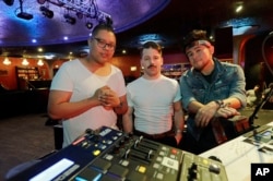 Members of the band A R I Z O N A, from left, David Labuguen, Zachary Charles, and Nate Esquite, pose for a photo before a concert in Seattle, June 4, 2019.
