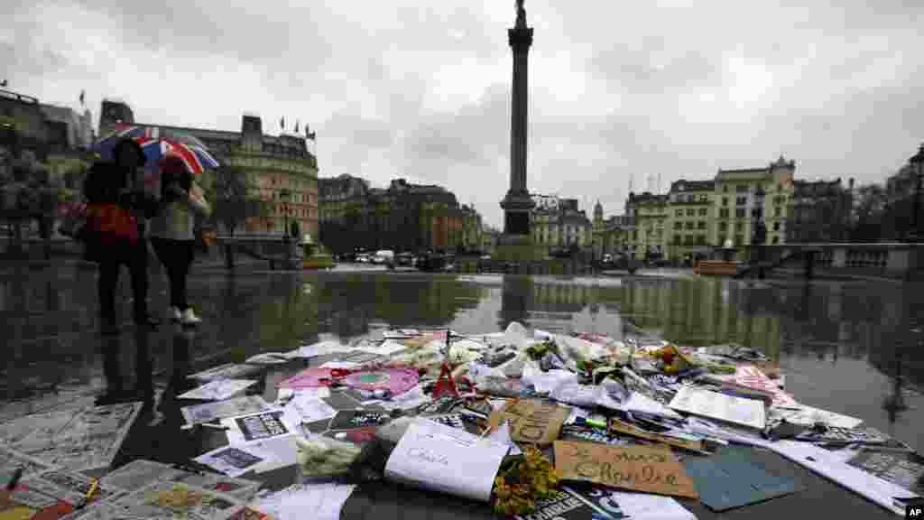 Des fleurs et des stylos et des pancartes sont déposés en signe de solidarité avec les personnes tuées dans une attaque dans les bureaux parisiens de l&#39;hebdomadaire Charlie Hebdo, à Trafalgar Square, à Londres, le 8 janvier 2015.