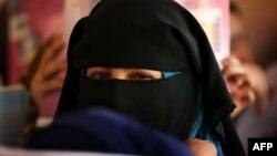 FILE - A girl wearing a hijab is seen attending school. Citing no evidence of discrimination, a Czech court has ruled against a Somali nursing school who challenged a school policy against hijabs.