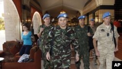 U.N. monitors walk through a hotel in Damascus, April 16, 2012.