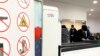 Passengers prepare to place items through Nuctech security scanners at the Brussels Eurostar train terminal on Jan. 17, 2022.