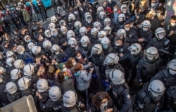 Turkish police officers detain protesters during a rally in support of Bogazici University students protesting the appointment of Melih Bulu, a ruling Justice and Development Party loyalist, as rector of the university, in Istanbul, Feb. 4, 2021.