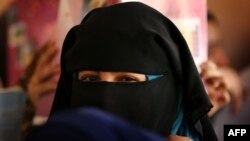 An Iraqi girl looks on as she attends a class at a school in west Mosul on July 27, 2017.