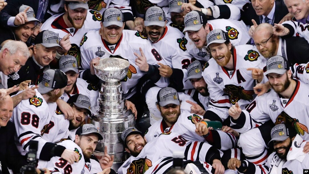 The Chicago Blackhawks pose with the Stanley Cup after beating the Boston Bruins 3-2 in Game 6 of the NHL hockey Stanley Cup Finals, June 24, 2013, in Boston.