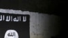 FILE - An Iraqi soldier inspects a recently-discovered train tunnel, adorned with an Islamic State group flag, that belonged to the former Baghdad to Mosul line, that was turned into a training camp for IS fighters, in western Mosul, Iraq, March 1, 2017.