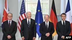 (L-R) British Prime Minister Keir Starmer, US President Joe Biden, German Chancellor Olaf Scholz and French President Emmanuel Macron pose for a family photo at the start of their "Quad meeting" at the Chancellery in Berlin, on October 18, 2024.