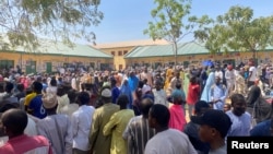 Voters, frustrated by polling station delays, wait to cast their vote during Nigeria's election, in Kano, Nigeria, Feb. 25, 2023.