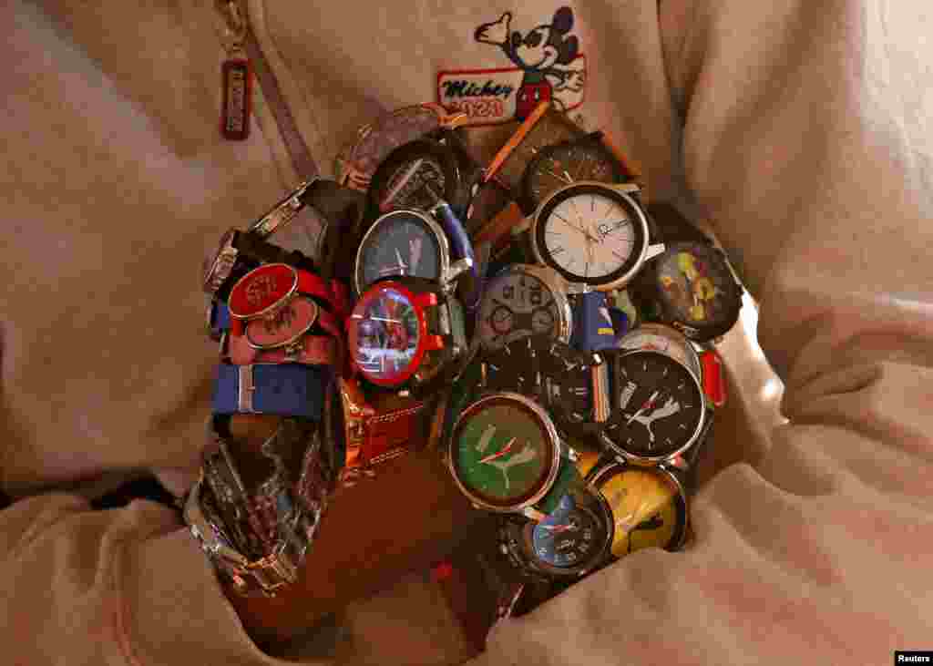 A street vendor sells wrist watches at a bus terminal in New Delhi, India.