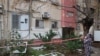 A woman inspects the damage as she evacuates her home in Tel Aviv, Israel, early on Dec. 21, 2024, after a projectile fired from Yemen landed near her building. 