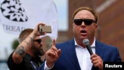 FILE - Alex Jones of Infowars speaks during a rally in support of then Republican presidential candidate Donald Trump in Cleveland, Ohio, July 18, 2016.