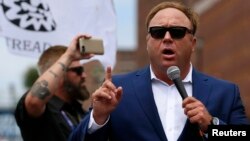 FILE - Alex Jones of Infowars speaks during a rally in support of then Republican presidential candidate Donald Trump in Cleveland, Ohio, July 18, 2016.