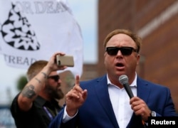 FILE - Alex Jones of Infowars speaks during a rally in support of then Republican presidential candidate Donald Trump in Cleveland, Ohio, July 18, 2016.
