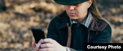 Photo shows unidentified Native American holding a cell phone. Courtesy, U.S. Department of Health and Human Services.