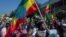 Ethiopians hold national flags as they gather at an event organized by city officials to honor the Ethiopian military, at the Abebe Bikila stadium in the capital Addis Ababa, Ethiopia, Nov. 17, 2020. 