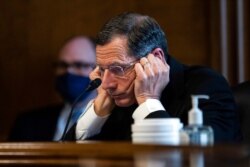 FILE - Senator John Barrasso, R-WY, listens to Rep. Deb Haaland, D-N.M., during a confirmation hearing, on Capitol Hill, Feb. 23, 2021.
