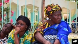 Relatives sit outside the Abdoul Aziz Sy Dabakh Hospital in Tivaouane, Senegal, a town 90 kms ( 60 miles) east of Dakar, where 11 newborns died in a blaze on Wednesday, May 25, 2022. 