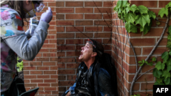 Një punonjëse e mediave duke u ndihmuar nga një infermiere protestuese pas përdorimit të gazit nga policia gjatë protestave për vrasjen e afrikano-amerikanit George Flloyd
