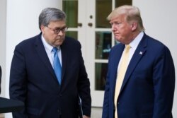 FILE - Attorney General William Barr, left, and President Donald Trump in the Rose Garden of the White House, July 11, 2019, in Washington.