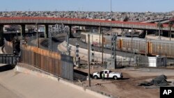 In this Tuesday, Jan. 22, 2019, photo, a new barrier is built along the Texas-Mexico border near downtown El Paso. Such barriers have been a part of El Paso for decades and are currently being expanded.