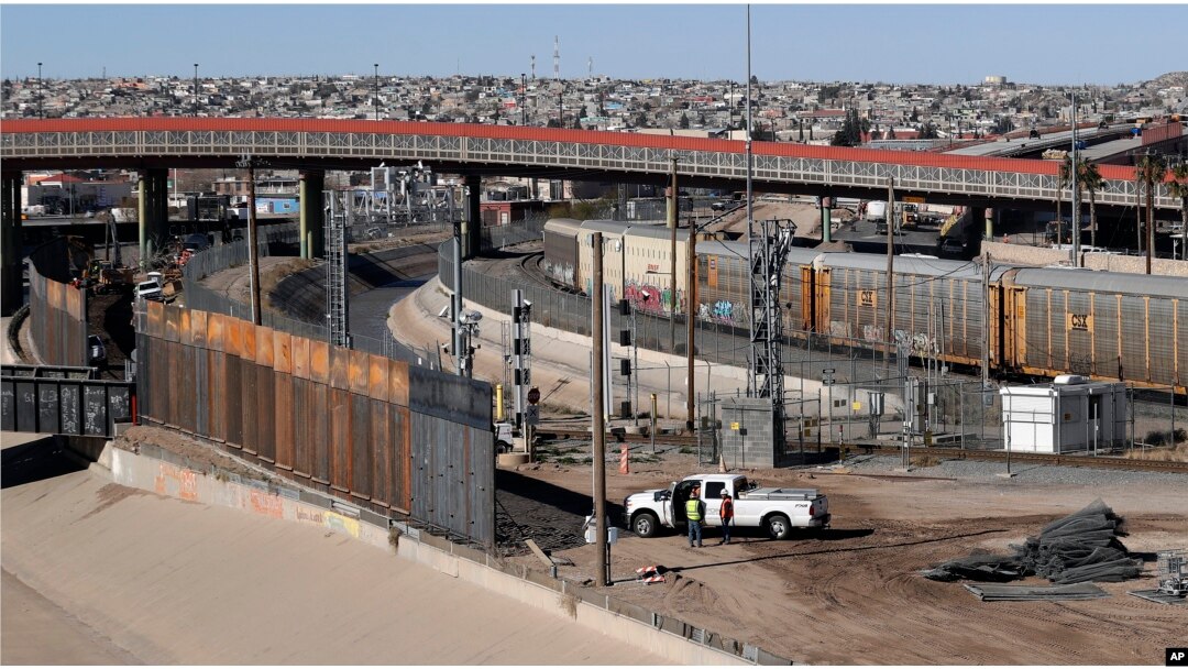 In this Tuesday, Jan. 22, 2019, photo, a new barrier is built along the Texas-Mexico border near downtown El Paso. Such barriers have been a part of El Paso for decades and are currently being expanded.