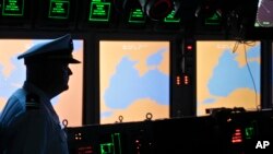 FILE - A U.S. Navy officer is seen on the USS Monterey as screens display the Black Sea region, in the port of Constanta, Romania, June 7, 2011. On Thursday, U.S. and NATO officials will declare operational a missile defense shield at one of its sites in Deveselu, Romania.