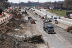 FILE - Work proceeds on an Interstate Highway 75 project in Hazel Park, Michigan., April 20, 2020.