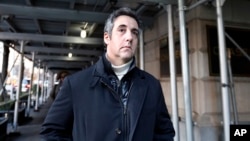 FILE - Michael Cohen, former lawyer to President Donald Trump, leaves his apartment building in New York, Dec. 7, 2018.