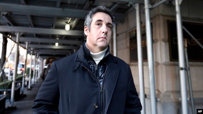 FILE - Michael Cohen, former lawyer to President Donald Trump, leaves his apartment building in New York, Dec. 7, 2018.
