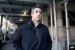 FILE - Michael Cohen, former lawyer to President Donald Trump, leaves his apartment building in New York, Dec. 7, 2018.