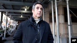 FILE - Michael Cohen, former lawyer to President Donald Trump, leaves his apartment building in New York, Dec. 7, 2018.