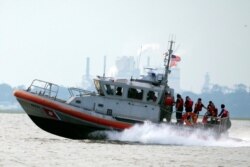 A United States Coast Guard vessel heads back to base with several members of the rescue team aboard after the last crew member was reportedly removed safely from the capsizes cargo shop Golden Ray, Sept. 9, 2019, in Jekyll Island, Georgia.