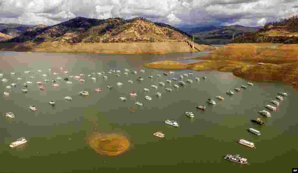 Houseboats float on Lake Oroville, Oct. 25, 2021, in Oroville, California. Recent storms raised the reservoir more than 4.8 meters, according to the California Department of Water Resources.