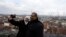 In this photo taken Dec. 16, 2016, Abd Alwahab Alahamad and his wife Iman Mshanati take a selfie atop the castle overlooking the town of Gray, eastern France. 