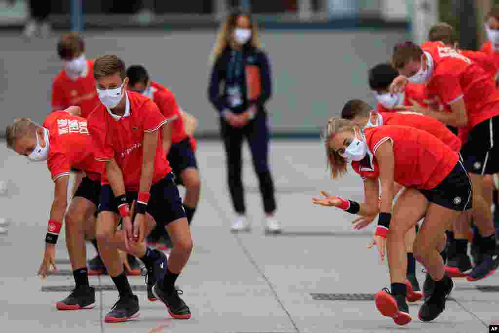 Ball girls and boys exercise before the second round matches at the 2020 French Open tennis tournament at the Roland Garros Stadium in Paris, France.