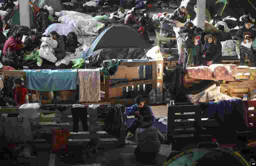 Migrants settle in the logistics center of the checkpoint &quot;Bruzgi&quot; at the Belarus-Poland border near Grodno, Belarus.