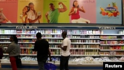 FILE - Shoppers are seen in the dairy section of a supermarket in Kenya's capital Nairobi, July 18, 2014.