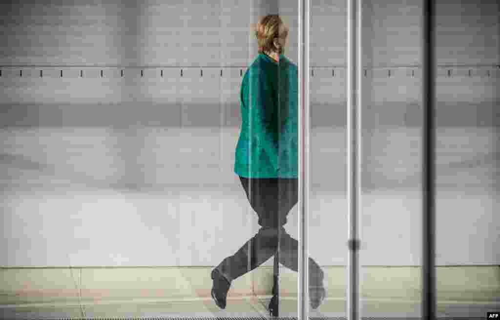 German Chancellor and leader of the Christian Democratic Union party Angela Merkel leaves the parliamentary compound of the Bundestag in Berlin after the parliamentary group of the CDU/CSU elected a new leader.