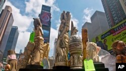 U.S. government display confiscated illegal ivory before crushing more than a ton in an effort to halt elephant poaching and ivory trafficking, Friday, June 19, 2015 at Times Square in New York.