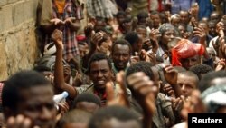 Ethiopian migrants, stranded on Yemen's border with Saudi Arabia, recite prayers appealing for evacuation to their home country from the western Yemeni town of Haradh, March 30, 2012.