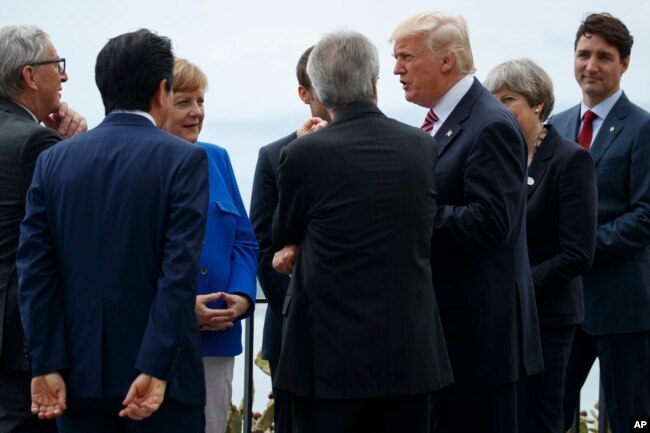 President Donald Trump poses for photos with G7 leaders at the Ancient Greek Theater of Taormina during the G7 Summit, May 26, 2017, in Taormina, Italy.