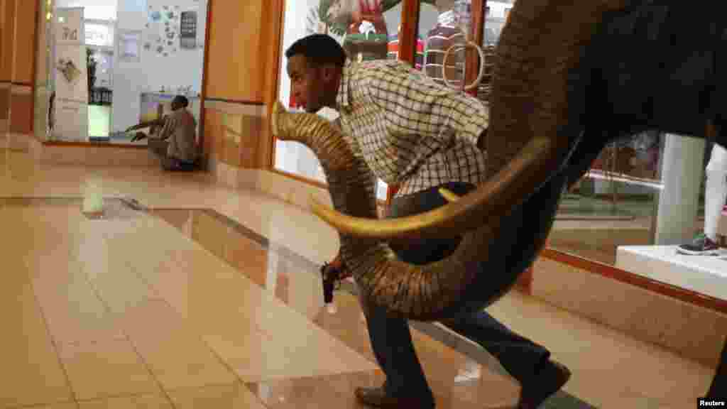 Armed police search through Westgate Shopping Mall for gunmen in Nairobi, September 21, 2013.