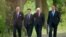 Foreign Ministers of France Laurent Fabius, Ukraine Pavlo Klimkin, Germany Frank-Walter Steinmeier and Russia Sergey Lavrov, from left, go for a walk before a meeting at the Guesthouse of Foreign Ministry Villa Borsig in Berlin, Sunday, Aug. 17, 2014.