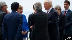 President Donald Trump poses for photos with G-7 leaders at the Ancient Greek Theater of Taormina during the G-7 Summit, May 26, 2017, in Taormina, Italy. 