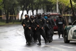 Police officers arrive at the area where a shooting took place in Mexico City, Mexico, June 26, 2020.