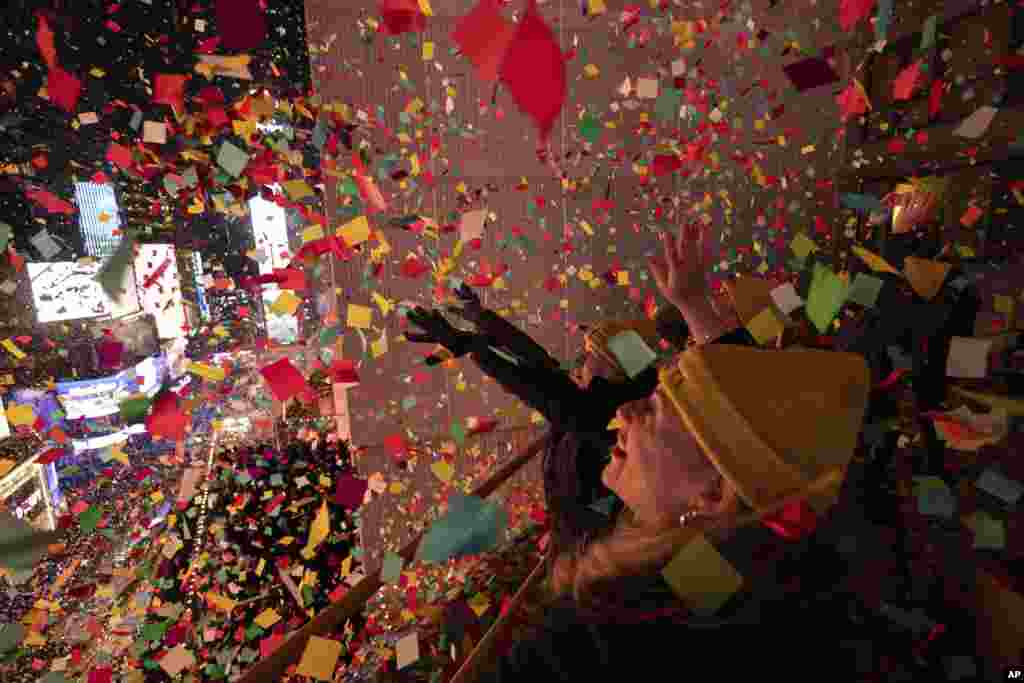 Times Square Alliance volunteers throw confetti during the New Year's Eve celebration in Times Square, Jan. 1, 2024, in New York.