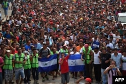 Honduran migrants heading in a caravan to the US, hold a demonstration demanding authorities to allow the rest of the group to cross, in Ciudad Hidalgo, Chiapas state, Mexico after crossing from Guatemala, Oct. 20, 2018.