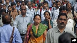 Commuters make their way on the platform at the Churchgate train station during the morning rush hour in Mumbai, India, October 31, 2011.