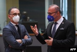 German Foreign minister Heiko Maas (L) talks with Crotian Foreign minister Gordan Grlic Radman (R) during a Foreign Affairs Council meeting at the EU headquarters in Brussels on July 12, 2021.