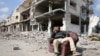 A Palestinian sits among the rubble of buildings destroyed during the Israeli offensive, amid a ceasefire between Israel and Hamas, in Rafah in the southern Gaza Strip, Feb. 4, 2025. 